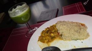 Quinoa with vegetable curry and a glass of cucumber, celery and ginger juice